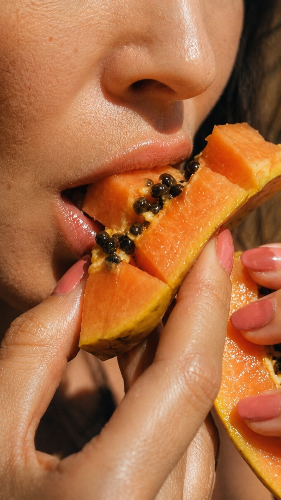 Close-up of lips meeting ripe papaya — the soft-fruit reset behind SugahJam™.