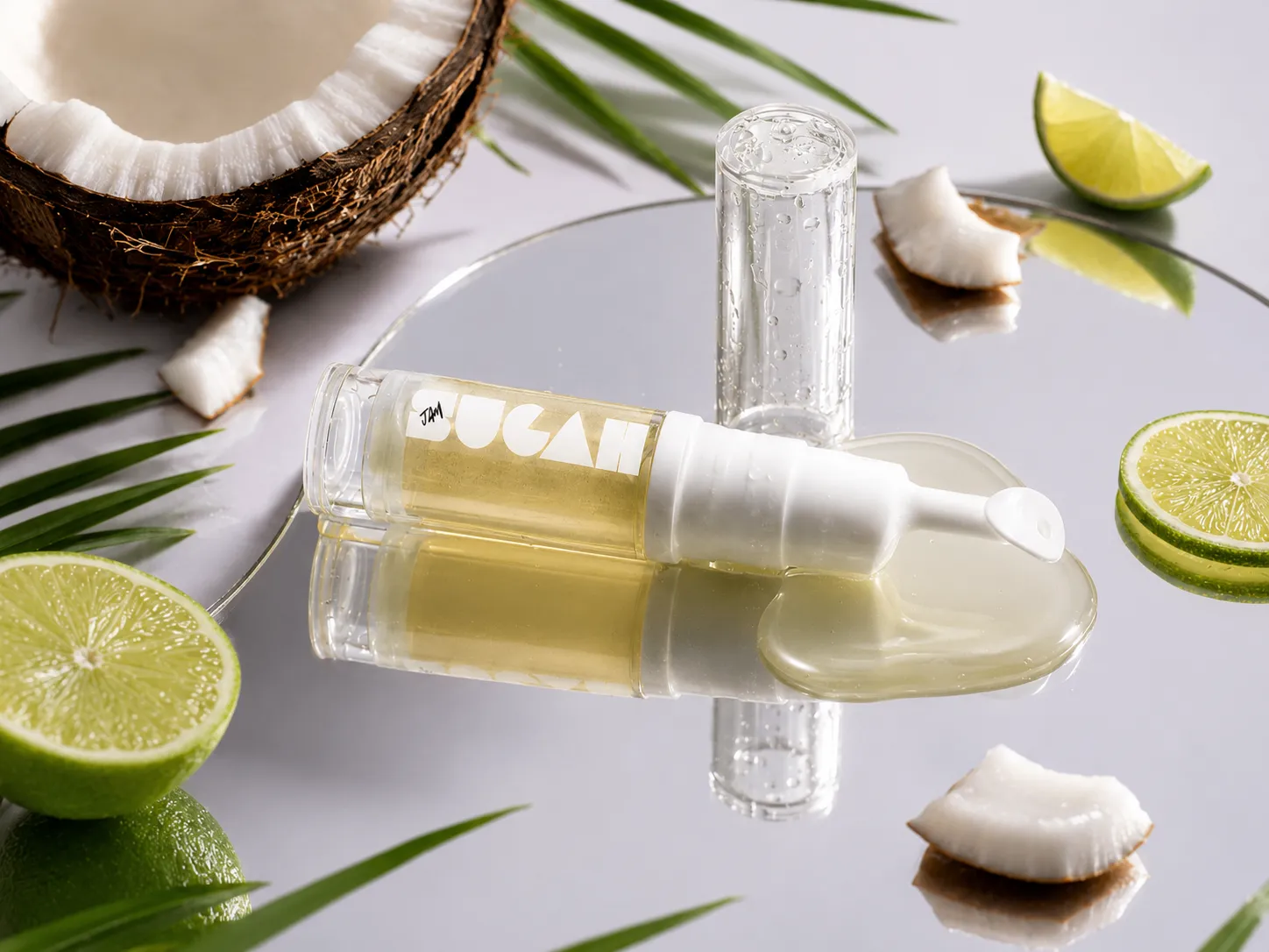 SugahJam™ Jelly Lip Mask in Coconut Key Lime styled with fresh coconut and lime, showing the golden jelly texture.